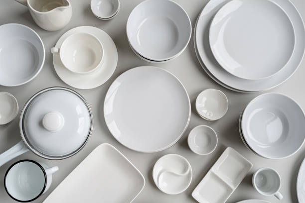 istock piles of white ceramic dishes and tableware top view on gray background 1209725366