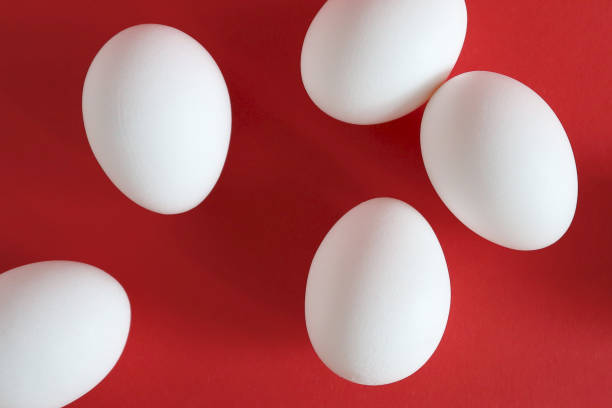 istock White eggs lie on a red background. Happy easter concept, top view. 1209725438