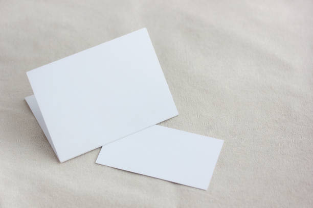 istock mockup, template with an empty white cardboard postcard and a business card. 1209730932
