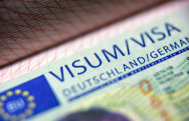 Visa stamp in passport close-up. German visitor visa at border control. Macro view of Schengen visa for tourism and travel in EU. stock photo