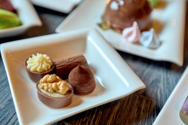 istock Plate of candy and a few plates with cakes 1209732573