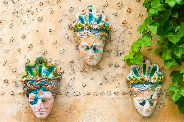 istock Masks on the wall with green plant for print 1209732834