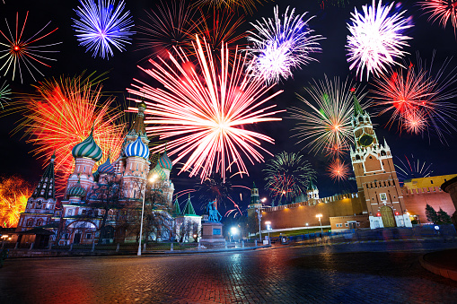 Saint Basil cathedral and Spasskaya tower of Moscow Kremlin on Red Square during night fireworks