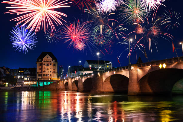Mittlere Brucke middle bridge across Rhine river at night, Basel during fireworks celebration