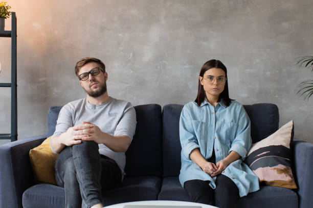 A young Couple is Sitting on the Couch with a Psychologist. Family Problem. stock photo