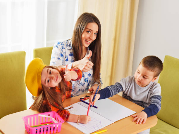 istock Mother with kids having fun time together - Thumbs up 1209736550