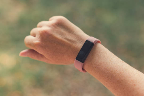 istock Female hiker with smart fitness tracker, 1209736757