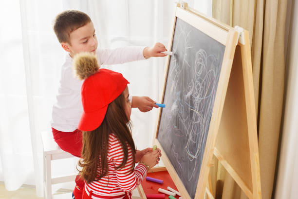istock Little kids drawing on the blackboard 1209736916