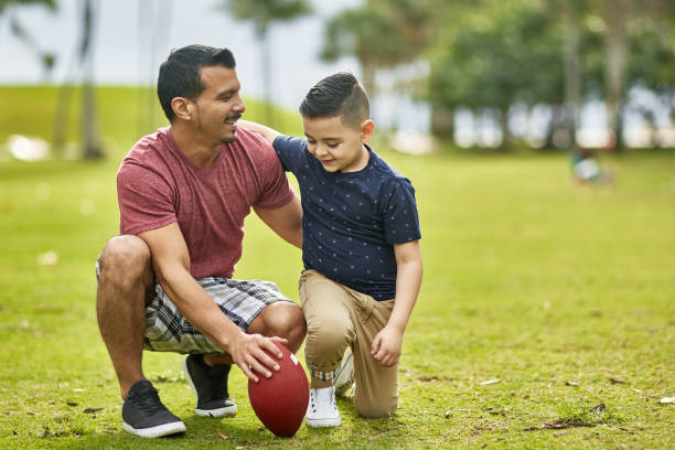 istock Hispanic Father and Son Exercising Together in Miami Park 1209737075