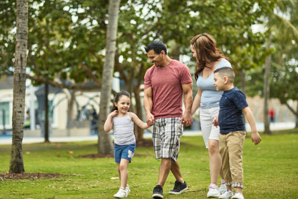 istock Young Hispanic Family Walking and Talking in Miami Park 1209737090