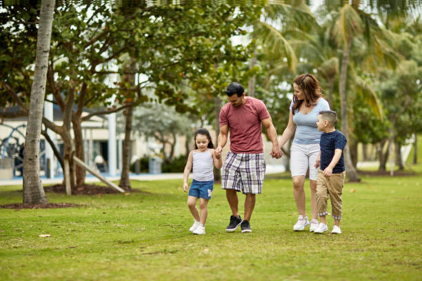 istock Hispanic Parents Holding Hands and Walking with Children 1209737284
