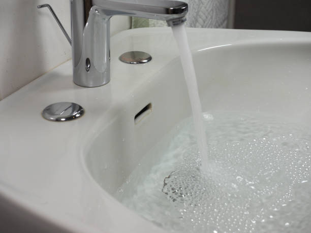 istock tap faucet in basin 1209740582