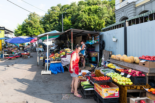 Kyiv, Ukraine - August 13, 2018: Old food market in Kiev city with people selling produce vendors fruits and vegetable stands