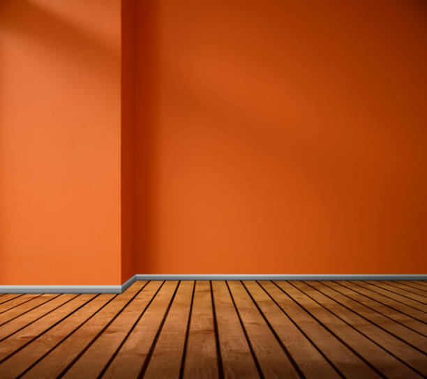 istock Empty Orange Wall and Wooden Floor with Room Background 1209742072