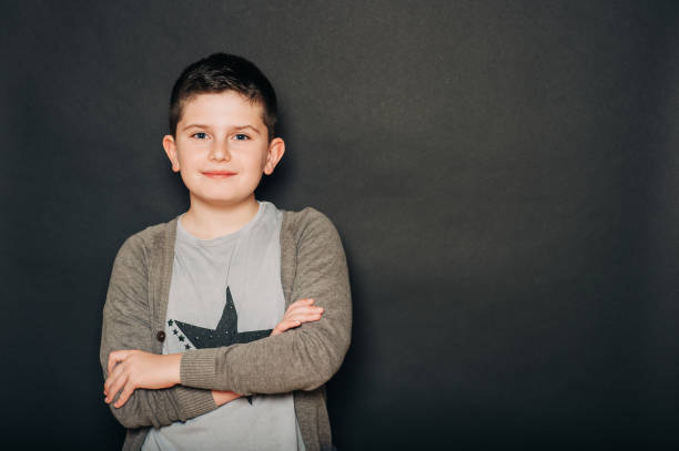 istock Studio portrait of handsome young boy posing on black background 1209743541