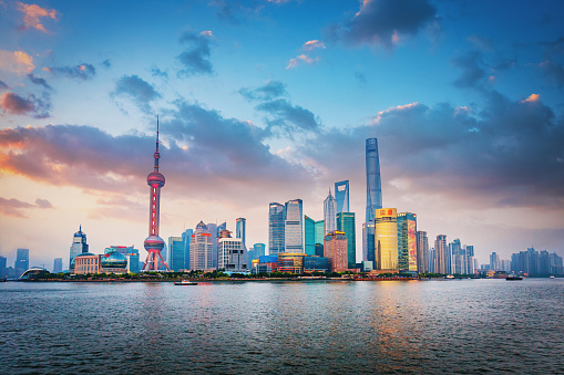 Beautiful sunset twilight over the Shanghai Skyline view to Pudong at Dusk Panoramic view over Huangpu River to the famous skyscrapers and Oriental Pearl Tower. Shanghai, Pudong, China, Asia