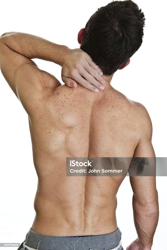 Man with neck or back aches Man with neck or back aches shot on white background  Backache Stock Photo