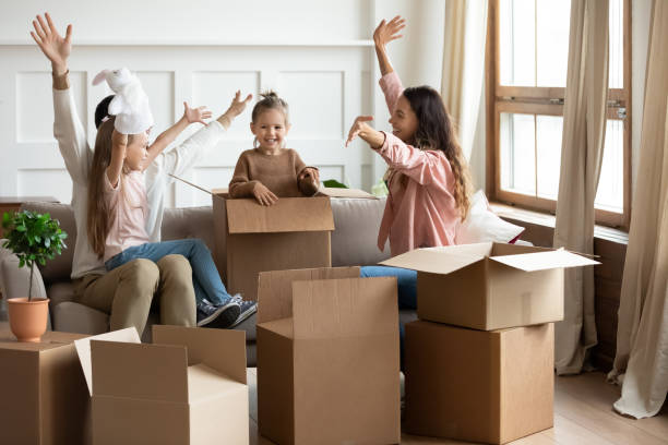 istock Overjoyed young parents play with little kids on moving day 1209762643