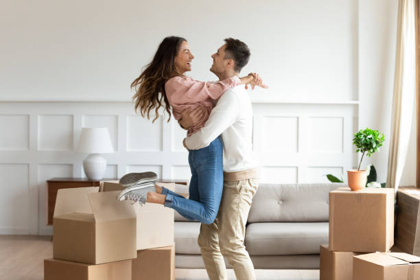 overjoyed couple dancing excite to move in together - couple imagens e fotografias de stock