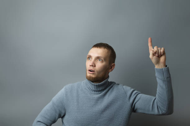 istock Man shows thumb up in surprise 1209763608