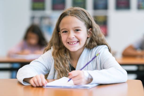 istock Smiling elementary age girl in classroom 1209763683