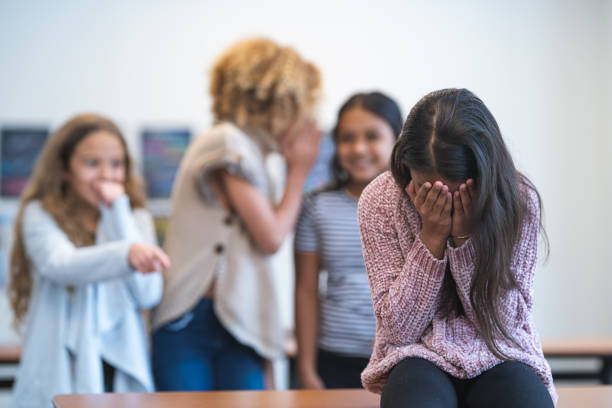 istock Elementary age girl being bullied by classmates 1209763690