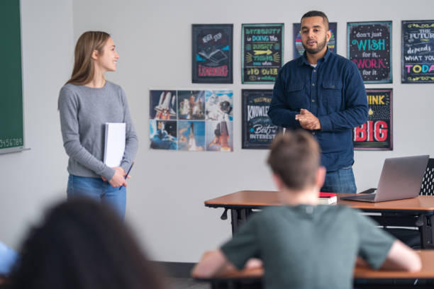 istock A teacher introduces a student to present to the class 1209763728
