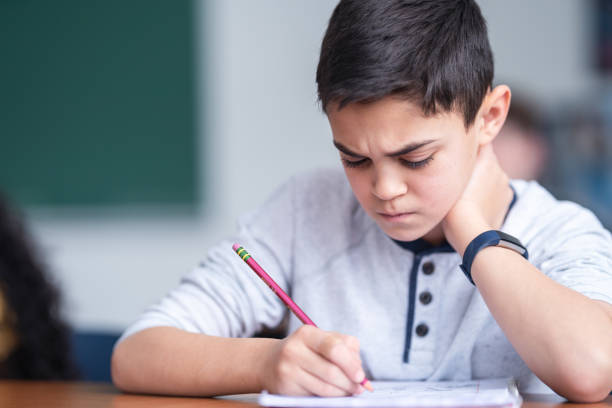 istock A young student appears stressed as he completes and exam 1209763731