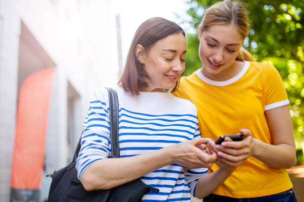 istock mother showing daughter mobile phone 1209764898