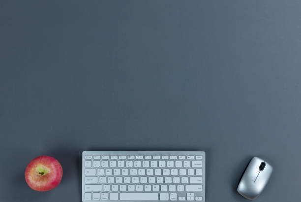 istock Gray office working desktop with technology and apple. Plenty of copy space. 1209768778
