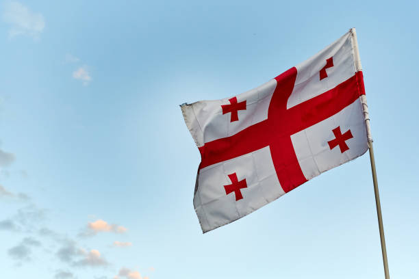 istock Georgia flag on blue sky background 1209769861