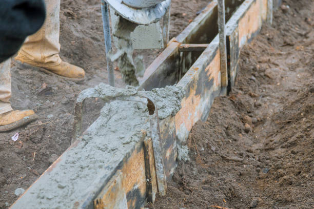 istock Pour concrete from concrete truck, Construction workers pouring concrete, selective focus 1209774157