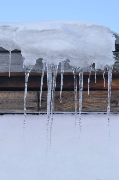 istock Icicles on the roof of the barn. A vertical image. 1209776849