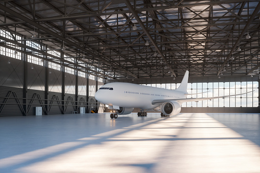 Roller shutter door and concrete floor of airport hangar and airplane background. Airport hangar from the outside with big tall doors. Front view. Aircraft Hangar 4K