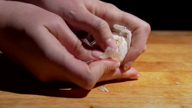 garlic cloves being peeled closeup