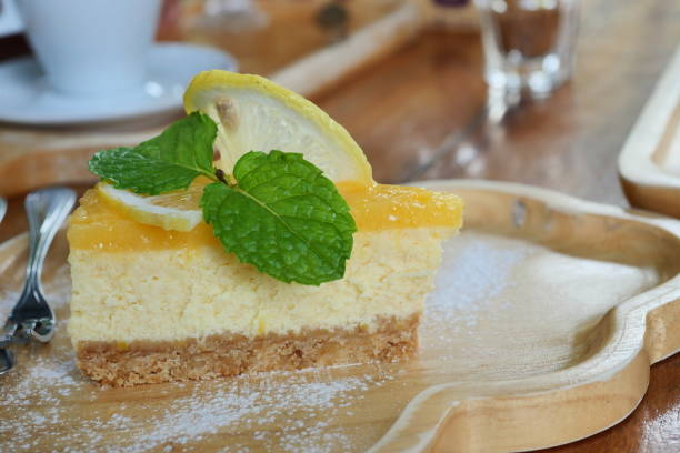 istock Cheesecake pie slice topped with lemon syrup and mint leaf 1209789308