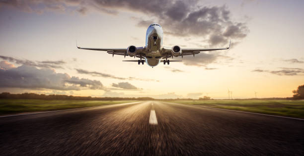 istock Airplane landing at Sunrise 1209789378