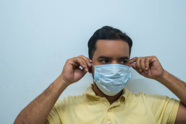 istock Man wearing a mask, white background. Virus concept 1209794068