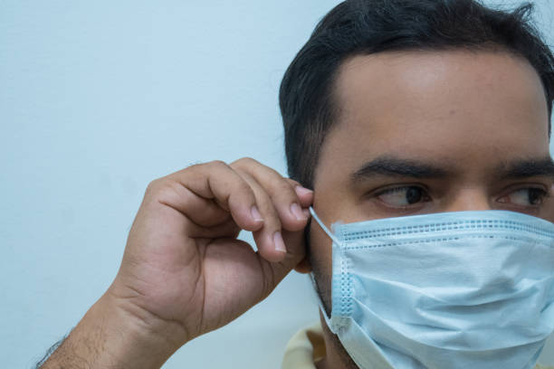 istock Man wearing a mask, white background. Virus concept 1209794071