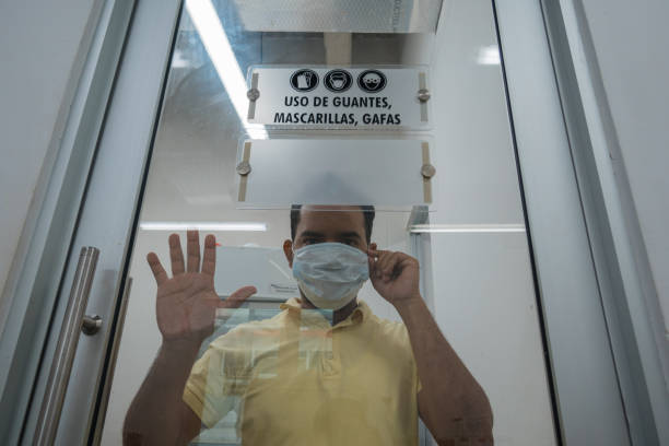 istock Man putting on a mask with a worried face. Virus concept 1209794128