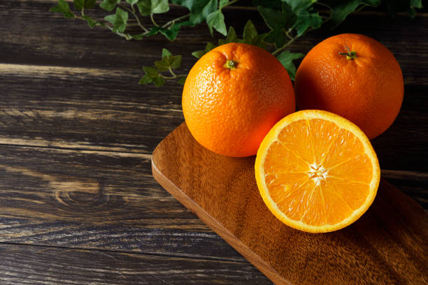 istock Fresh orange fruits isolated on wooden table 1209795512