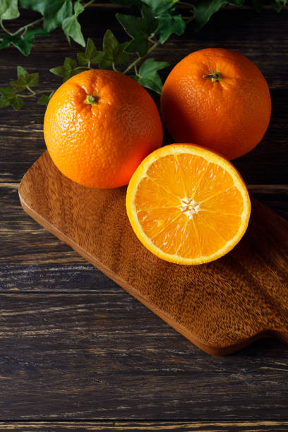 istock Fresh orange fruits isolated on wooden table 1209795523