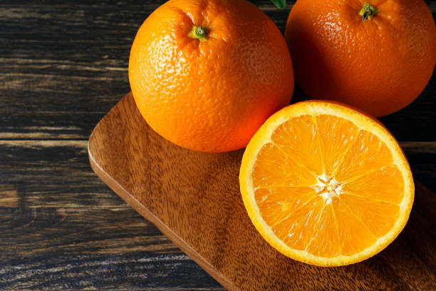 istock Fresh orange fruits isolated on wooden table 1209795551