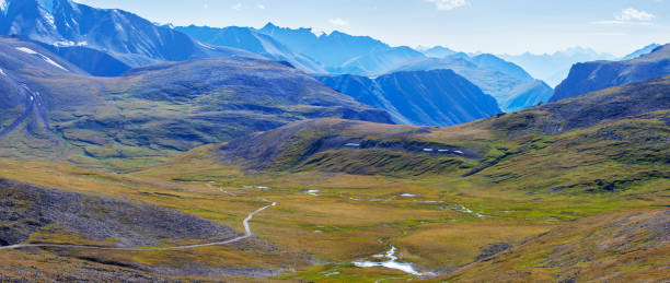 istock Alpine valley, peaks in a blue haze 1209800409