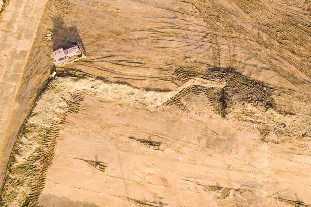 istock heavy duty bulldozer prepares a site for further construction. aerial view 1209801139