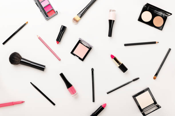 istock Make-up cosmetics products and tools set. Contouring powder, highlighter, blush, lipstick kit, makeup brushes, lip pencil, eyeliner on white background. Maquillage and beauty concept top view 1209802758