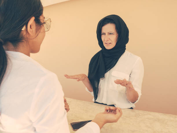istock Serious Muslim female customer consulting professional 1209802963