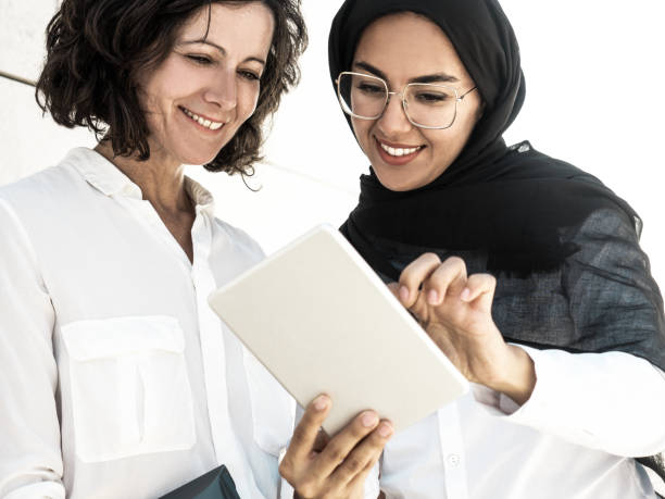 istock Happy multicultural female employees watching presentation 1209805046