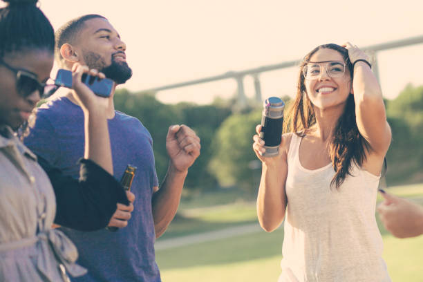 istock Relaxed people dancing with beer bottles at party. 1209805221
