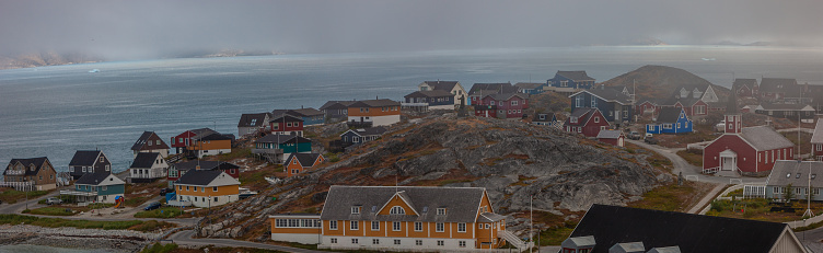 Colorfull houses and the old church in Nuuk the capital of Greenland of a foggy day